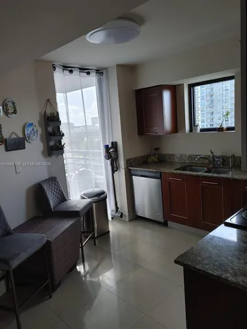 a kitchen with stainless steel appliances granite countertop a stove and a microwave