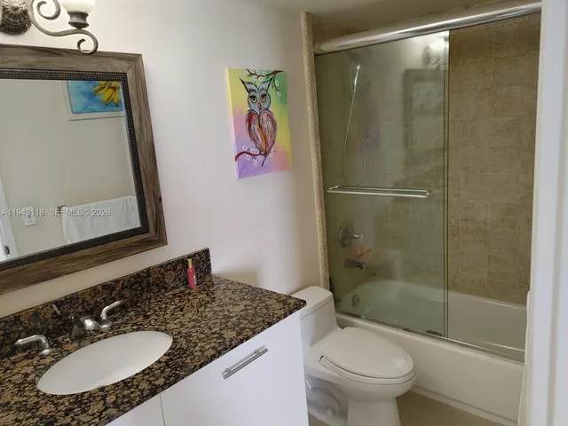 a kitchen with stainless steel appliances granite countertop a refrigerator stove and microwave