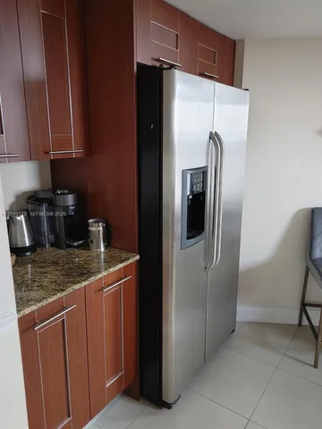 a bathroom with a granite countertop double vanity and a mirror