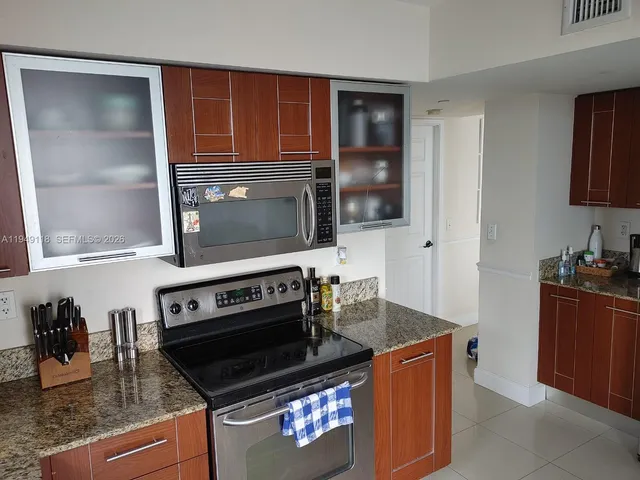 a bedroom with furniture and a flat screen tv
