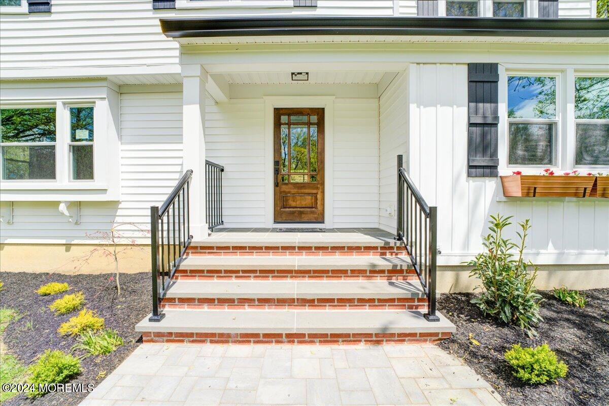 3 Beverly Drive Holmdel, NJ 07733 - Photo 10 of 37 a front view of a house with outdoor seating and plants