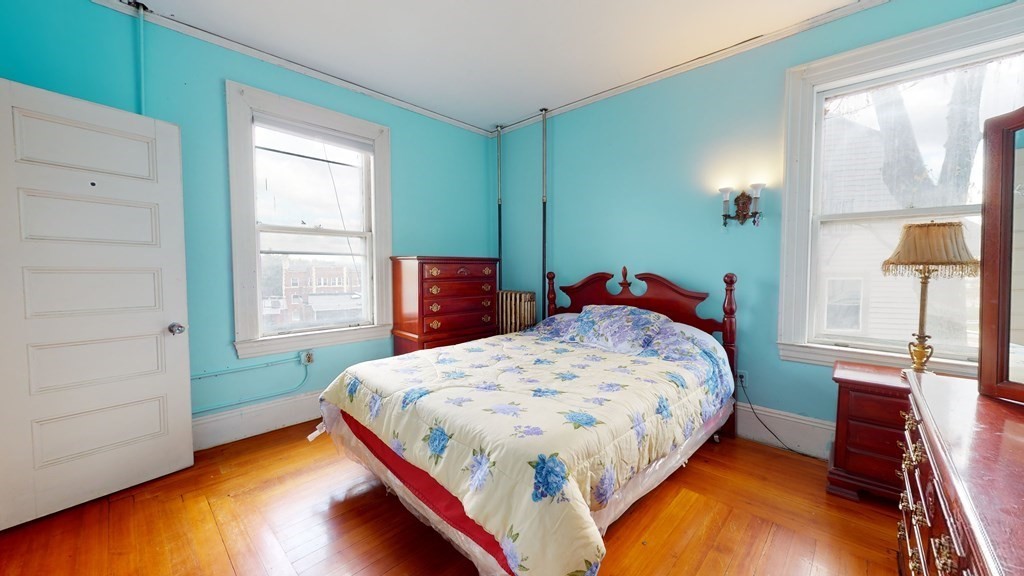 384 Arborway Boston, MA 02130 - Photo 13 of 39 a bedroom with a bed and a window