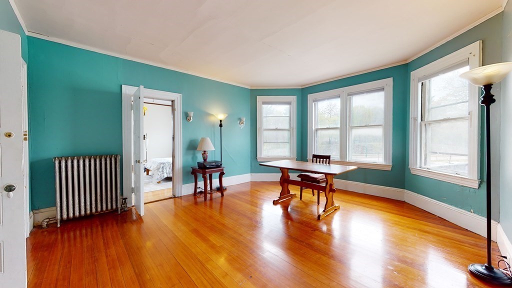 384 Arborway Boston, MA 02130 - Photo 15 of 39 a view of a livingroom with furniture and wooden floor