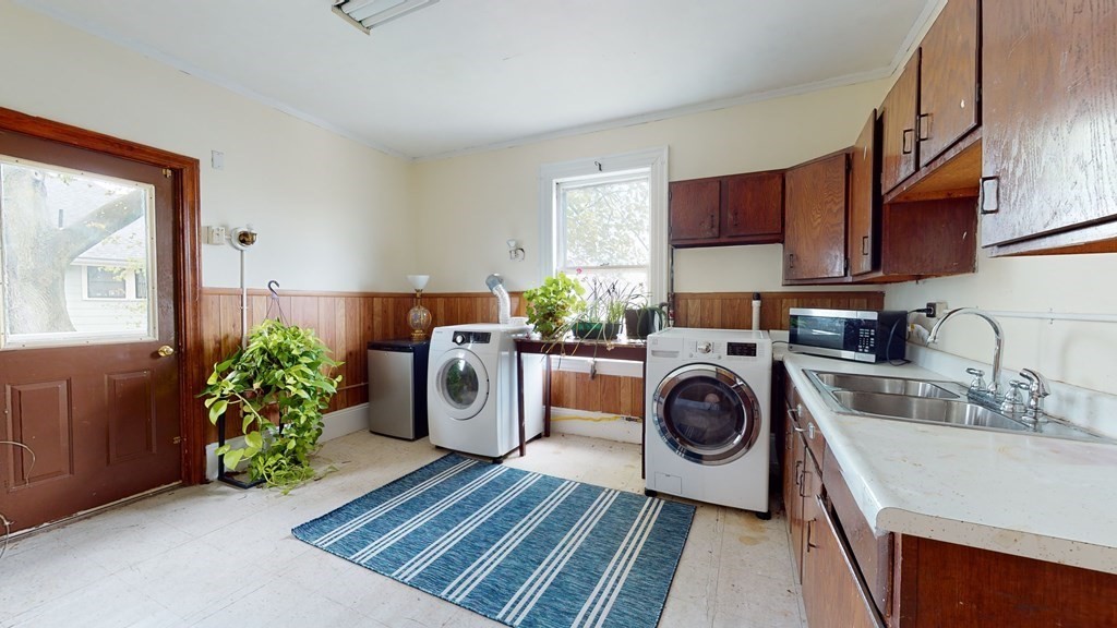 384 Arborway Boston, MA 02130 - Photo 16 of 39 a utility room with sink dryer and washer