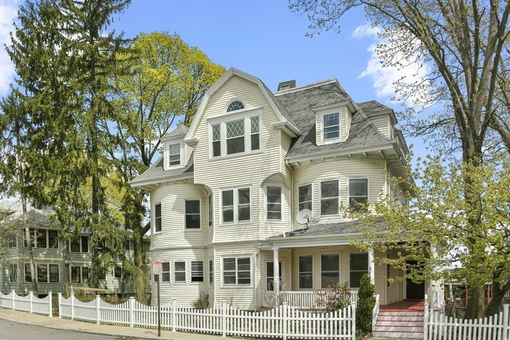 384 Arborway Boston, MA 02130 - Photo 2 of 39 a front view of a residential apartment building with a yard