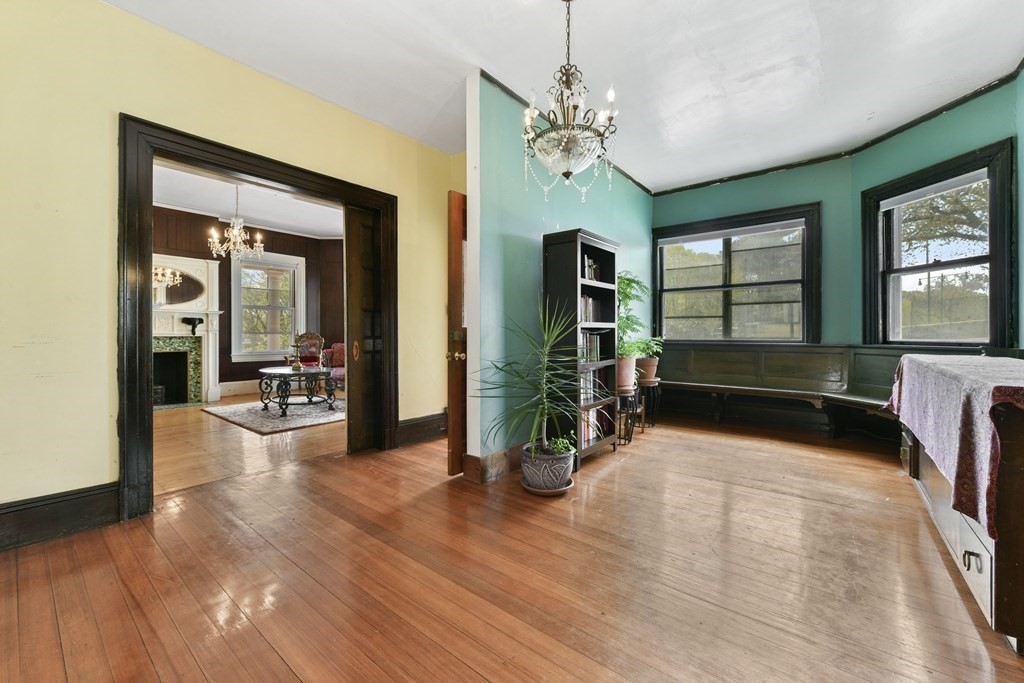 384 Arborway Boston, MA 02130 - Photo 8 of 39 a view of a livingroom with furniture hardwood floor and windows