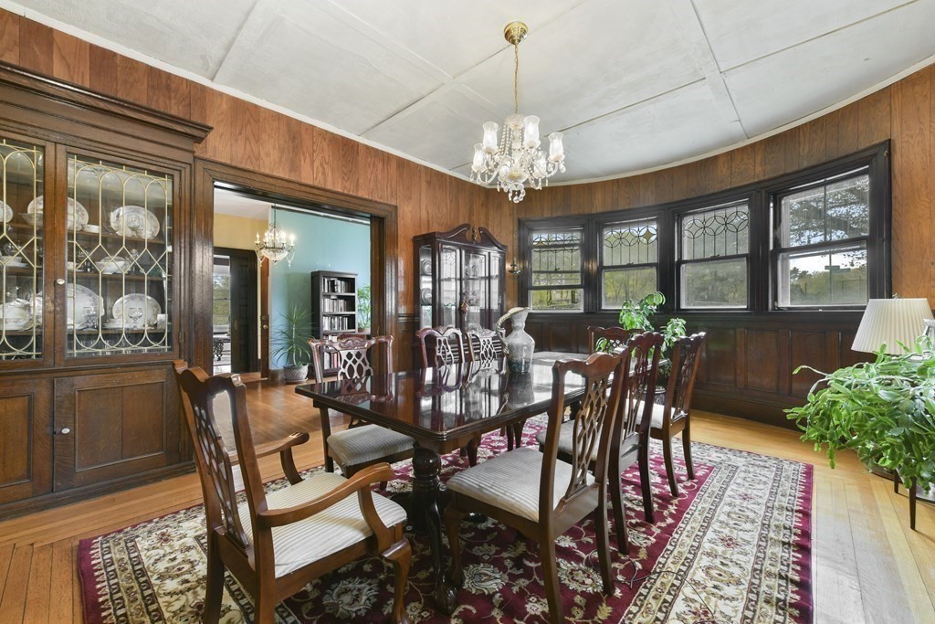 384 Arborway Boston, MA 02130 - Photo 9 of 39 a view of a dining room with furniture window and wooden floor