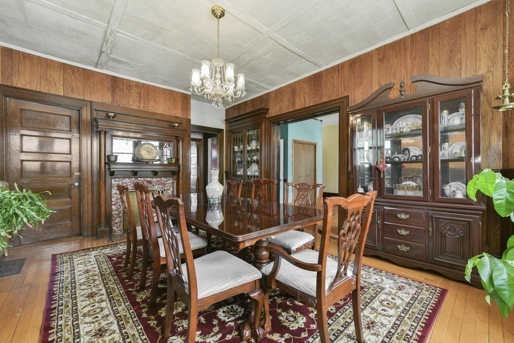 384 Arborway Boston, MA 02130 - Photo 10 of 39 a view of a dining room with furniture a chandelier and wooden floor