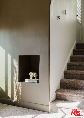 a view of a balcony with chairs and a potted plant