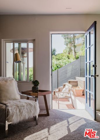 a view of living room filled with furniture and a potted plant