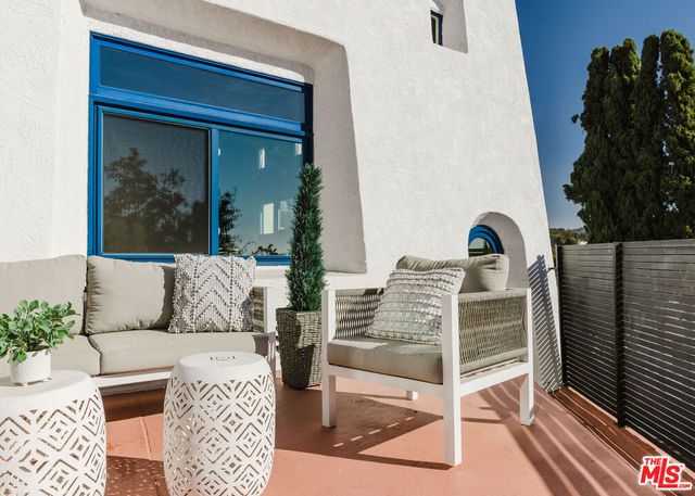 a terrace of a house with outdoor seating