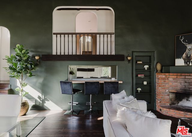 a living room with furniture fireplace and a potted plant
