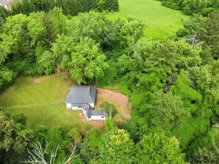 an aerial view of a house with a yard