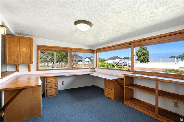 2252 West 800 North Clinton, UT 84015 - Photo 13 of 38 Room featuring built-in wood-finish cabinetry, integrated desk space, and expansive windows