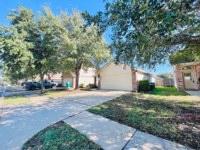 21606 Falvel Lake Drive Spring, TX 77388 - Photo 2 of 24 a view of a house with a yard and large trees