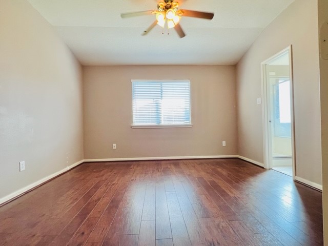 21606 Falvel Lake Drive Spring, TX 77388 - Photo 6 of 24 an empty room with wooden floor chandelier fan and windows