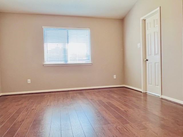 21606 Falvel Lake Drive Spring, TX 77388 - Photo 9 of 24 a view of an empty room with wooden floor and a window