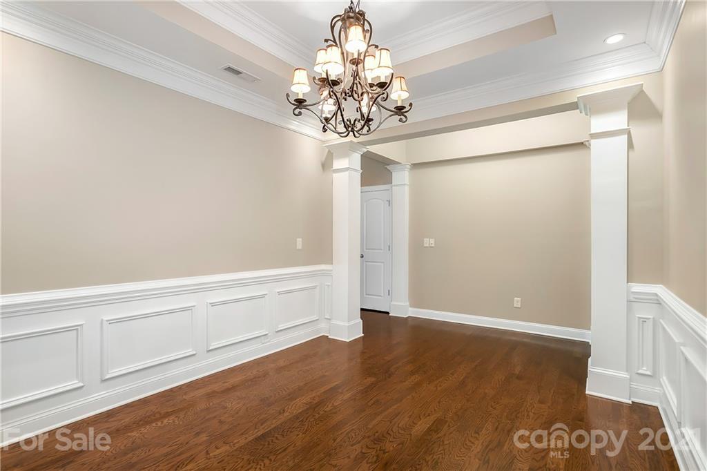 3108 Bridgewick Road Waxhaw, NC 28173 - Photo 11 of 42 a view of an empty room with chandelier and wooden floor