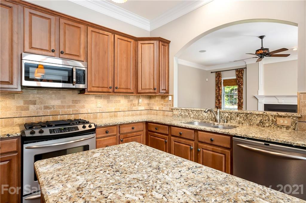 3108 Bridgewick Road Waxhaw, NC 28173 - Photo 13 of 42 a kitchen with a sink stove and microwave