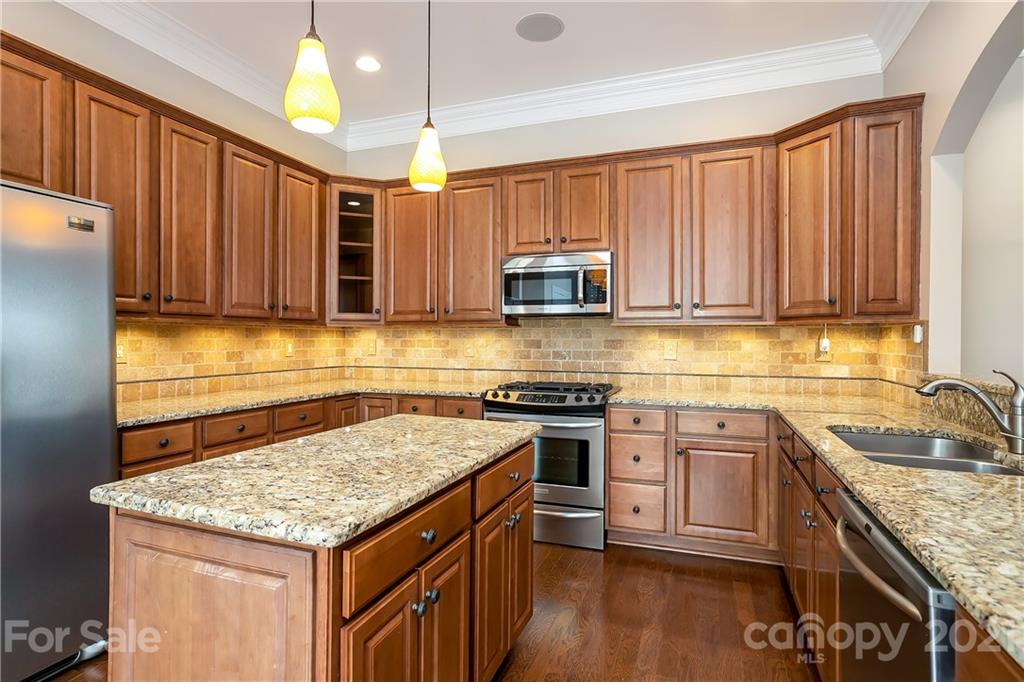 3108 Bridgewick Road Waxhaw, NC 28173 - Photo 14 of 42 a kitchen with stainless steel appliances granite countertop wooden cabinets stove a sink and dishwasher