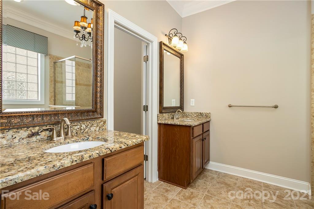 3108 Bridgewick Road Waxhaw, NC 28173 - Photo 22 of 42 a bathroom with a granite countertop sink and a mirror