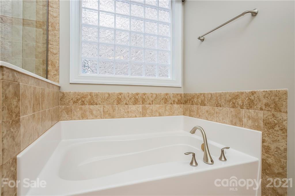 3108 Bridgewick Road Waxhaw, NC 28173 - Photo 24 of 42 a white bath tub sitting next to a window