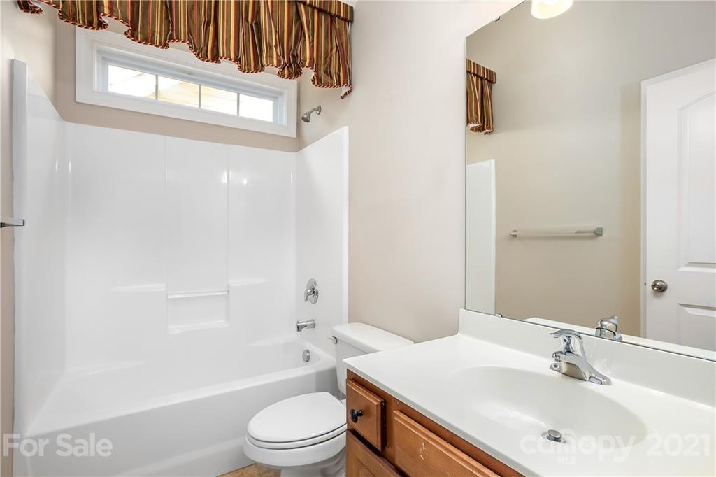 3108 Bridgewick Road Waxhaw, NC 28173 - Photo 34 of 42 a bathroom with a sink a toilet and a bathtub