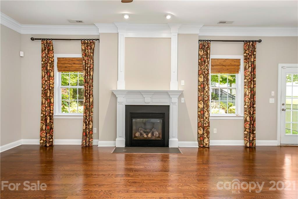 3108 Bridgewick Road Waxhaw, NC 28173 - Photo 6 of 42 a living room with a fireplace and wooden floor