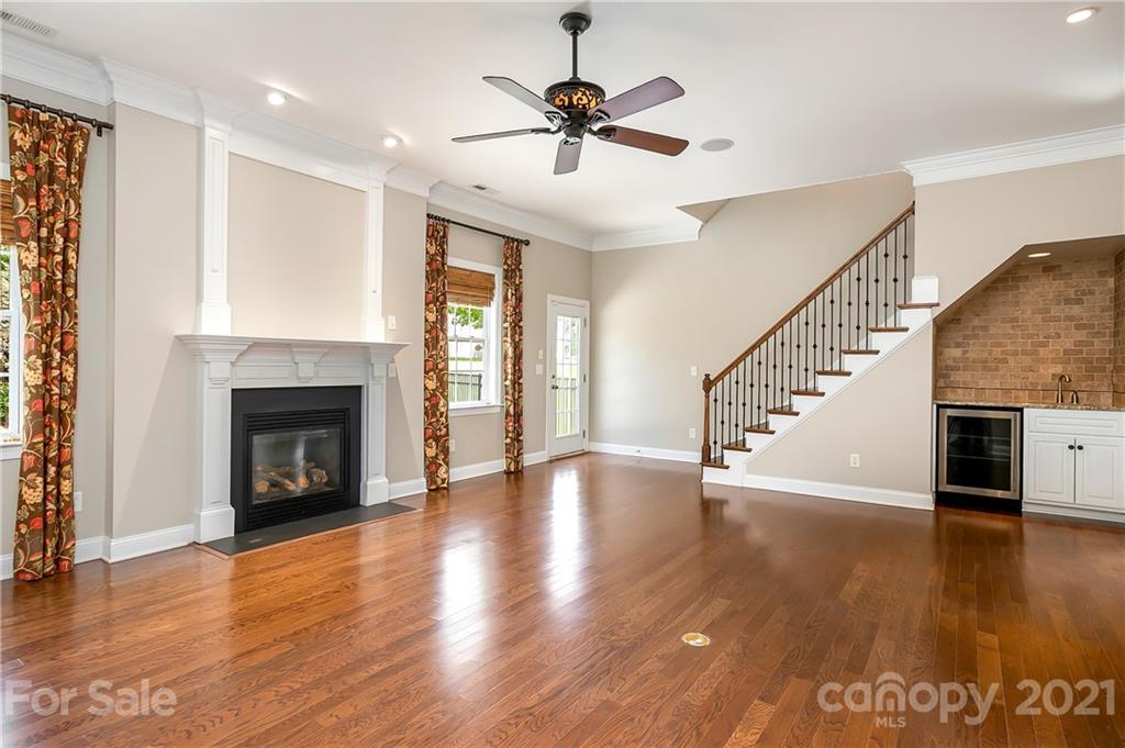 3108 Bridgewick Road Waxhaw, NC 28173 - Photo 7 of 42 a view of an empty room with wooden floor a fireplace and a window