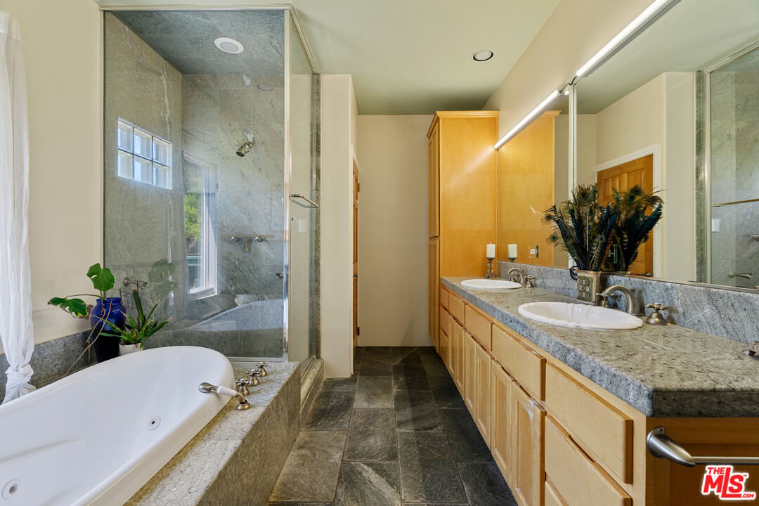 20912 Fontaine Road Topanga, CA 90290 - Photo 21 of 52 a spacious bathroom with a granite countertop tub sink and mirror