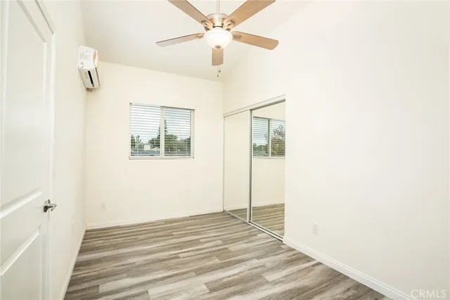 a view of a room with a ceiling fan and a window