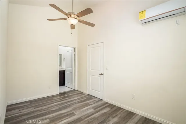 a view of a livingroom with wooden floor and a ceiling fan
