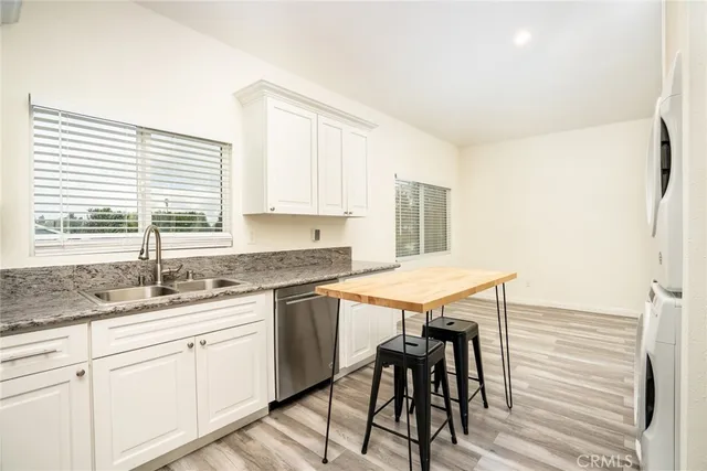 a kitchen with stainless steel appliances granite countertop a sink and a window