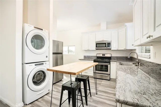 a kitchen with a stove a microwave and refrigerator