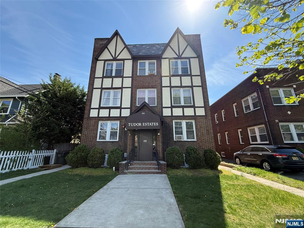 a front view of a residential apartment building with a yard
