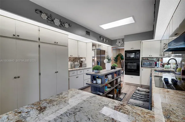 a bathroom with a sink a mirror and a toilet