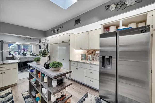 a living room with furniture a rug and a chandelier