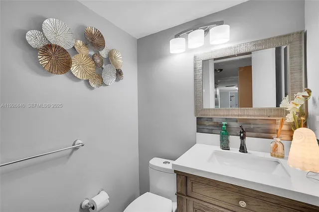 a bedroom with a large bed a rug and balcony