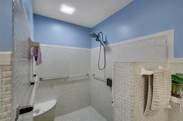 a bedroom with a bed table flowerpot and window