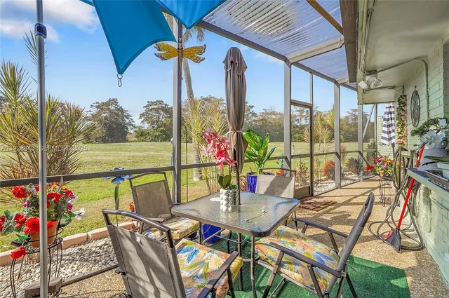 a outdoor space with patio the couches and a dining table with chairs with wooden floor