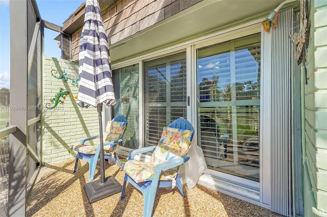 a view of swimming pool with outdoor seating and deck