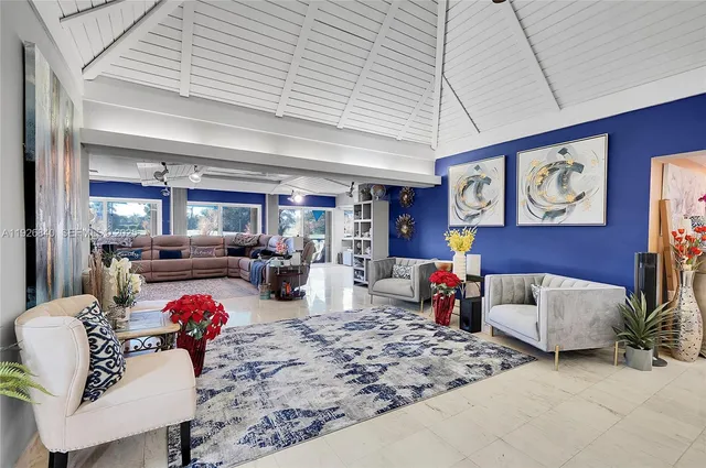 a view of a livingroom with furniture and a floor to ceiling window