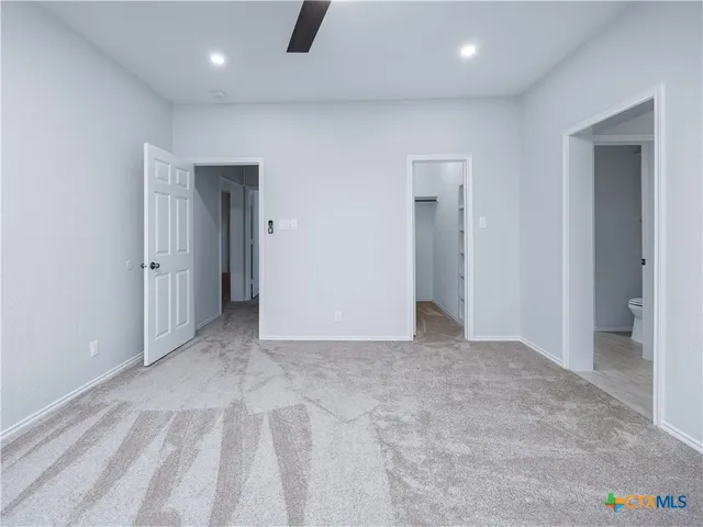 an empty room with closet and a window