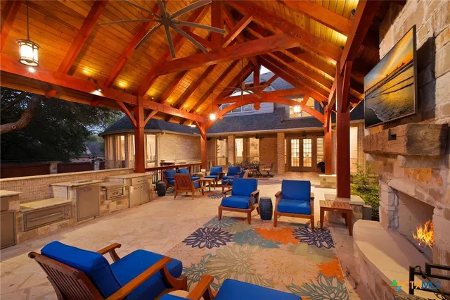 a outdoor space with lots of furniture and fireplace