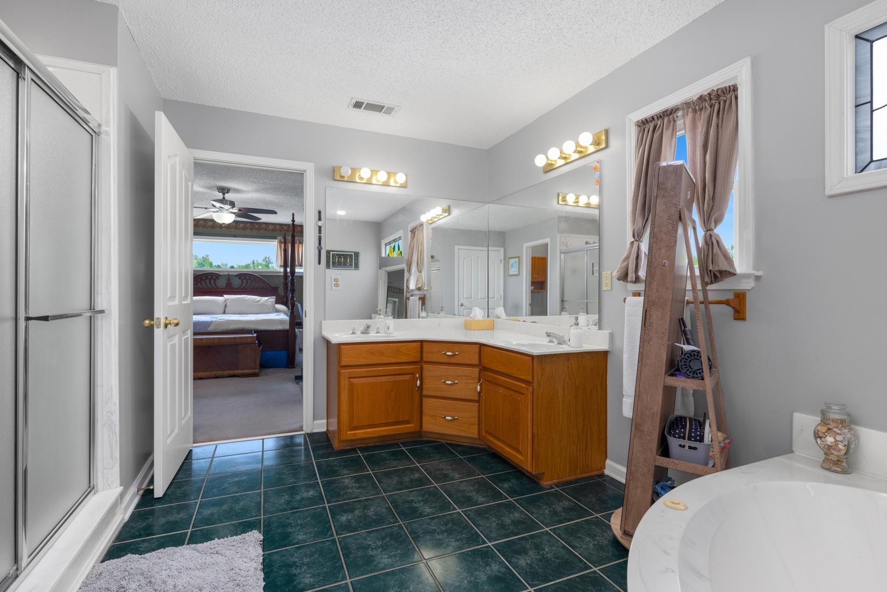 8539 Campground Road Drummonds, TN 38023 - Photo 22 of 38 a large bathroom with a sink a large mirror and a toilet