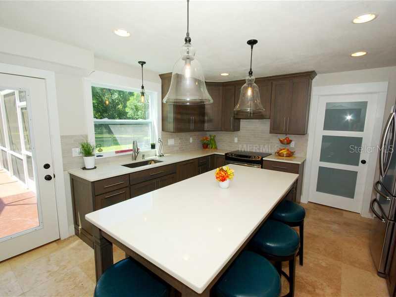 5017 Vanderipe Road Sarasota, FL 34241 - Photo 5 of 25 Kitchen - The kitchen has quartz counter tops, and new S/S appliances. The door to the right leads to the laundry room.