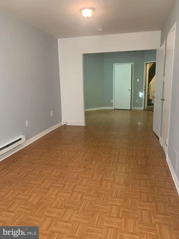 a view of a room with an empty space and window