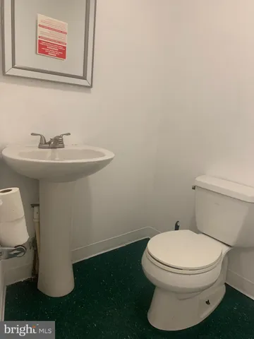 a white toilet sitting next to a bathroom sink