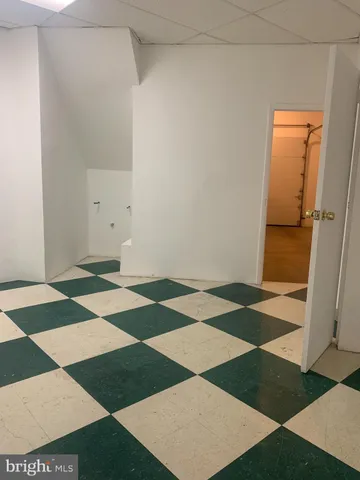 an empty room with a door and a rug