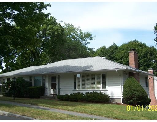 22 Cardinal Road Worcester, MA 01602 - Photo 2 of 31 a view of a white house with large windows and a yard with plants and large trees